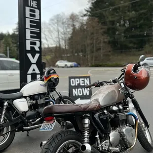 two motorcycles parked in a parking lot