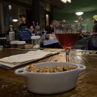 a bowl of food and a glass of wine