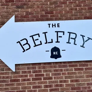 a sign on a brick wall