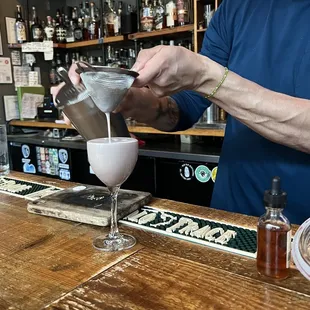 a bartender pouring a drink
