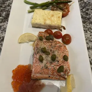 Wild Atlantic Salmon in lemon caper sauce with roe, au gratin potatoes, and roasted vegetables