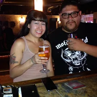a man and a woman holding beer glasses