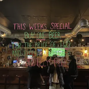 people standing in front of a bar
