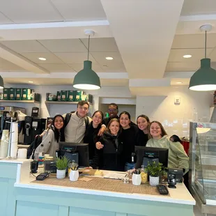 a group of people standing behind a counter