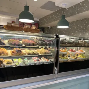 a display case of cakes and pastries