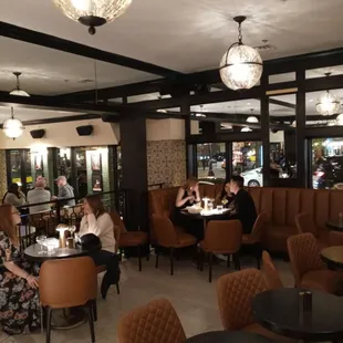 people sitting at tables in a restaurant