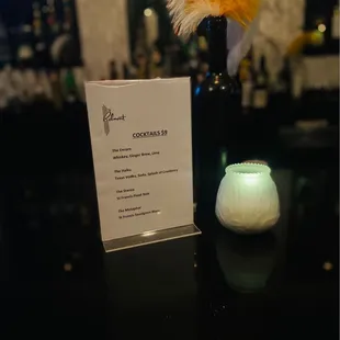 a menu and a candle on a table
