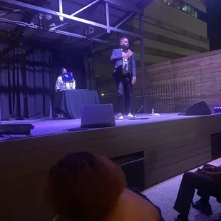 a man standing on a stage with a microphone