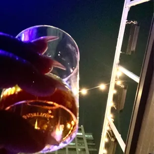 a hand holding a glass of wine