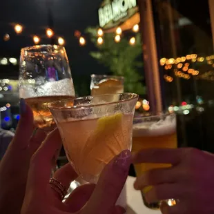 two people toasting with drinks