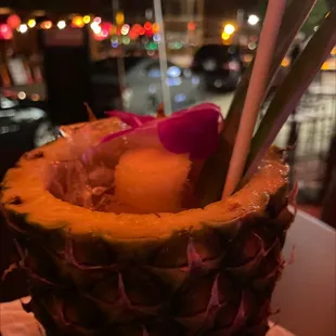 a pineapple with a flower in it