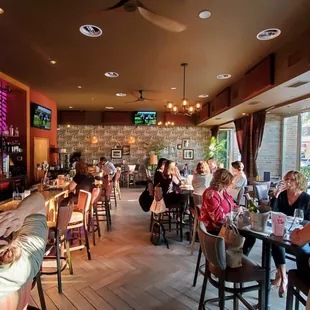 Happy Hour on a summer day with the windows open to the sidewalk.
