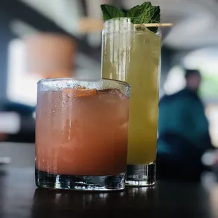 two cocktails on a bar