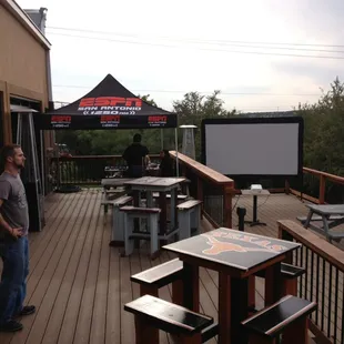 Outdoor patio showing sports on projection screen