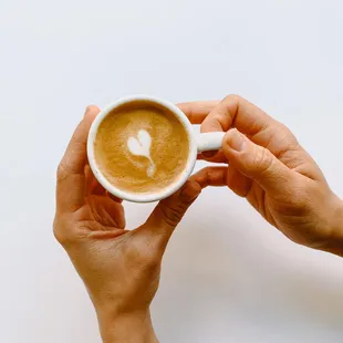 a person holding a cup of coffee