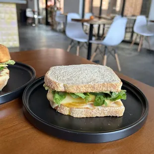 two sandwiches on plates