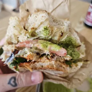 Inside my chicken sandwhich with pompano peppers grilled onions cheese and avacado. On a French roll.