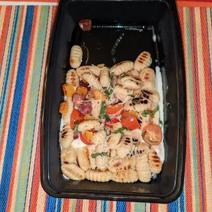 a tray of pasta and vegetables