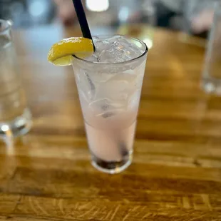 a glass of water with a lemon wedge