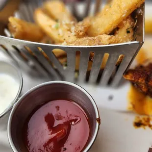 a basket of fries and dipping sauce