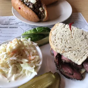 Half pastrami sandwich, coleslaw, and pickles. And, Philly cheese sandwich.