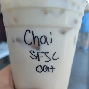 a hand holding a cup of coffee