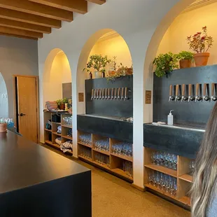 a woman standing in front of a bar