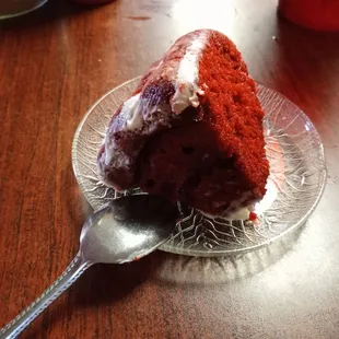 Slice of red velvet cake.  Notice they serve with a spoon.