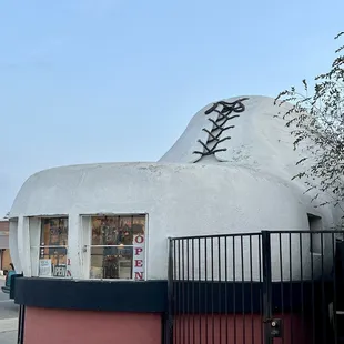A Shoe Repair shop is inside this Humungous Shoe Shaped Building that's 25 feet tall &amp; 32 foot long@  The Big Shoe Repair in Bakersfield CA.