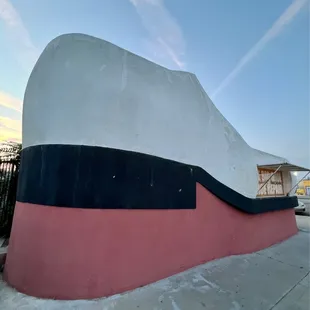 A Shoe Repair shop is inside this Humungous Shoe Shaped Building that's 25 feet tall &amp; 32 foot long@  The Big Shoe Repair in Bakersfield CA.