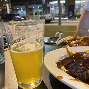 a plate of food and a glass of beer