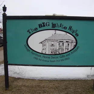 Main sign, adjacent to the street at the end of the sidewalk.