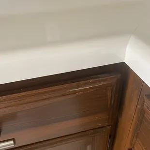 Chipped cabinets, covered in brown paint to "fix"