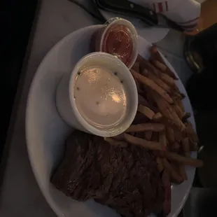 a plate of steak and french fries