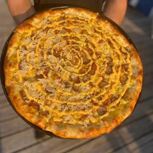 a person holding a pizza