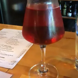 Glass of blackberry cider.