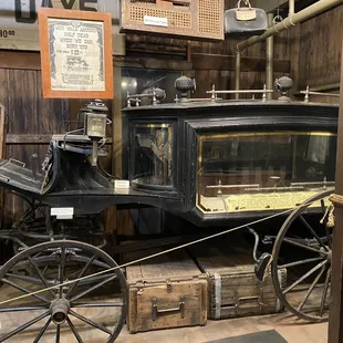 A very rare horse-drawn hearse with curved glass!