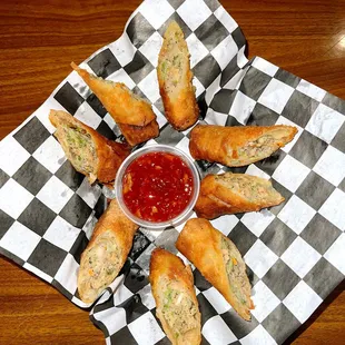 a plate of fried breadsticks and a bowl of ketchup