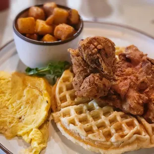 Chicken &amp; Waffels with a side of home fries and scrambled eggs with cheese.