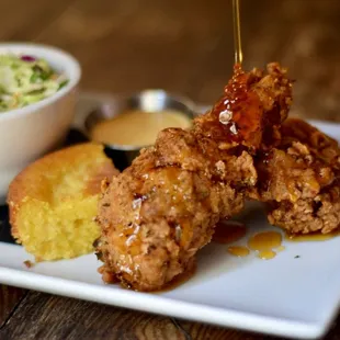 a plate of fried chicken with a side of coleslaw