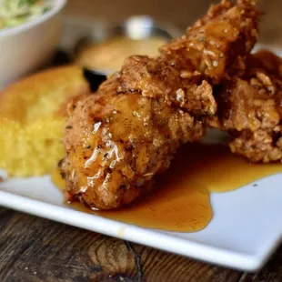 a plate of fried chicken with a side of coleslaw