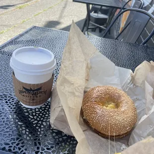 Seating area, decaf latte and bacon breakfast sandwich