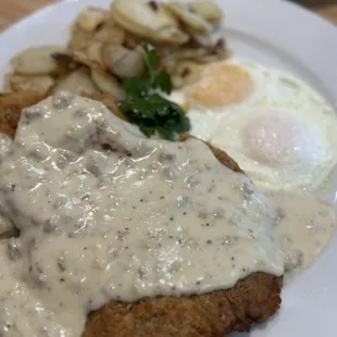Chicken Fried Steak, country potatoes, and eggs over easy