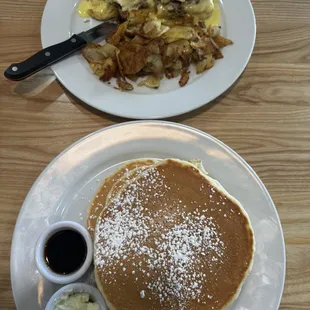 Tri tip Benedict on the top and a stack (3) of pancakes with maple syrup.