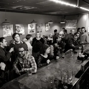 a group of people sitting at a bar