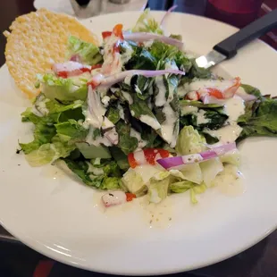 a white plate with a salad on it