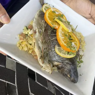 a person holding a plate of food