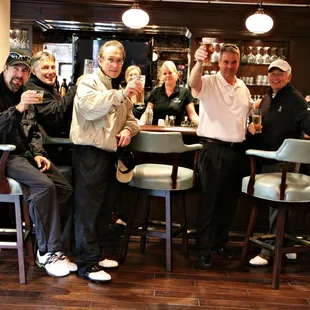 a group of people sitting at a bar
