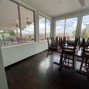 a view of a porch with rocking chairs