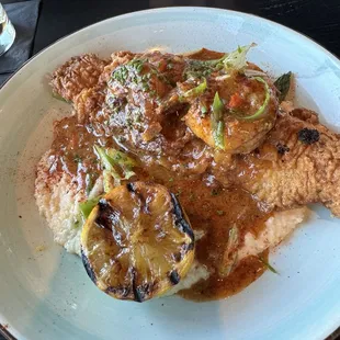 Catfish over white cheese grits topped with a creole mustard cream sauce and blackened shrimp.